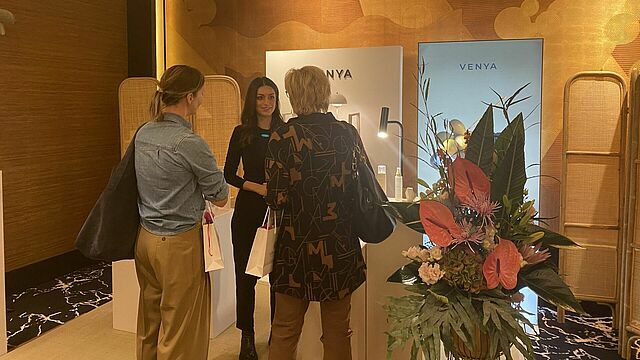 Personen stehen an einem Markenstand